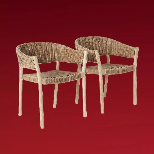 Pair of woven rattan dining chairs with natural wooden legs, modern curved backrests on red background