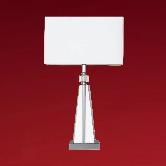 Modern chrome table lamp with white rectangular shade, isolated against deep red background, home décor lighting