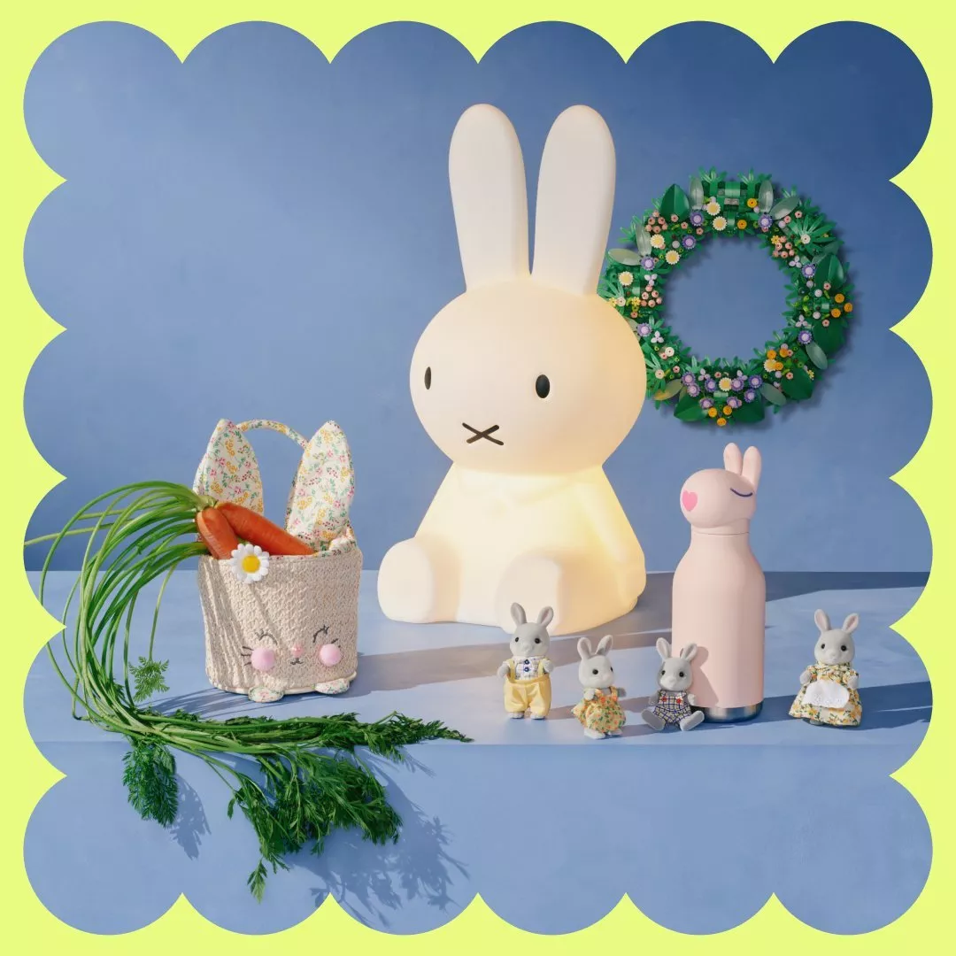 Cute bunny-themed decor with a glowing bunny lamp, toy rabbits, carrots in a basket, and a floral wreath.