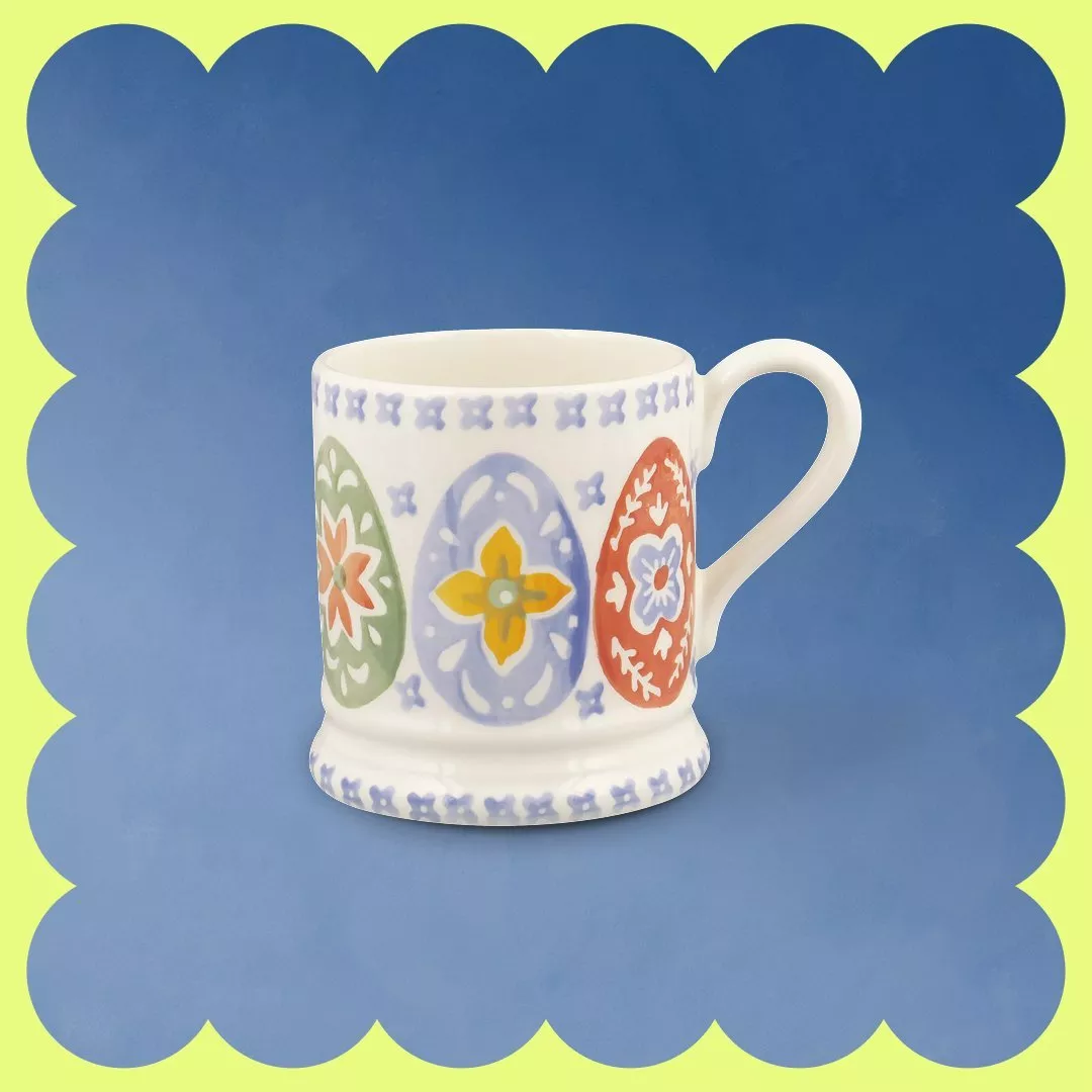 Gold locket with "poppy" engraving on a chain, set against a vibrant, swirling pastel background.