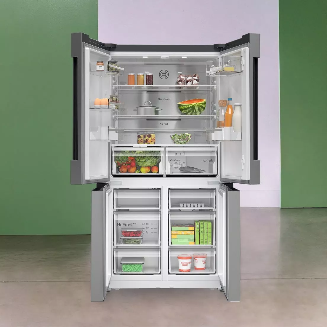 Open French door fridge freezer with no-frost drawers, stocked with fresh fruit, veg, milk and drinks.