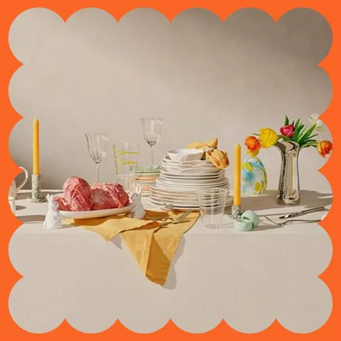 Giraffe toy floats in a starfish-patterned inflatable ring on a serene pool, surrounded by lush greenery.