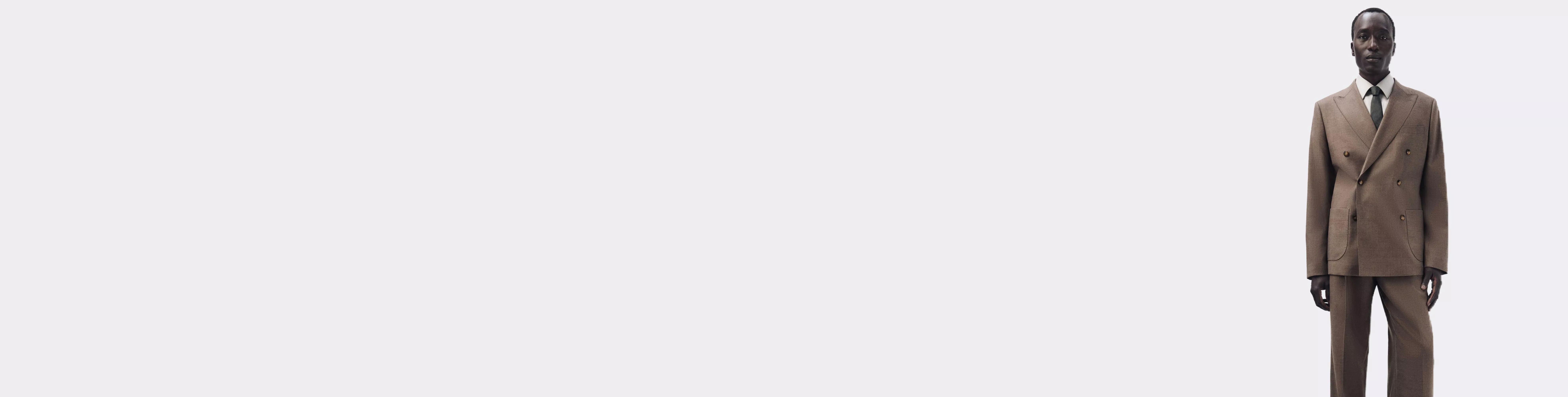 man wearing a brown suit on a neutral background