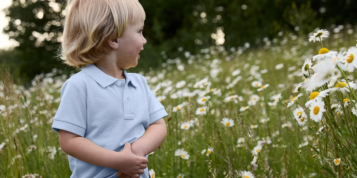 A image showing a boy in a field with flowers.
