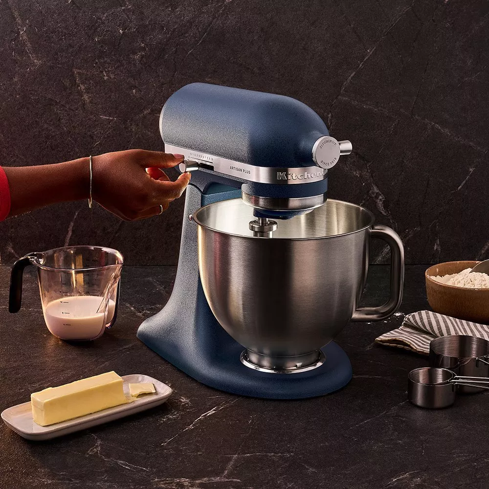 Matte black stand mixer with walnut wooden bowl on modern kitchen worktop, close-up product shot