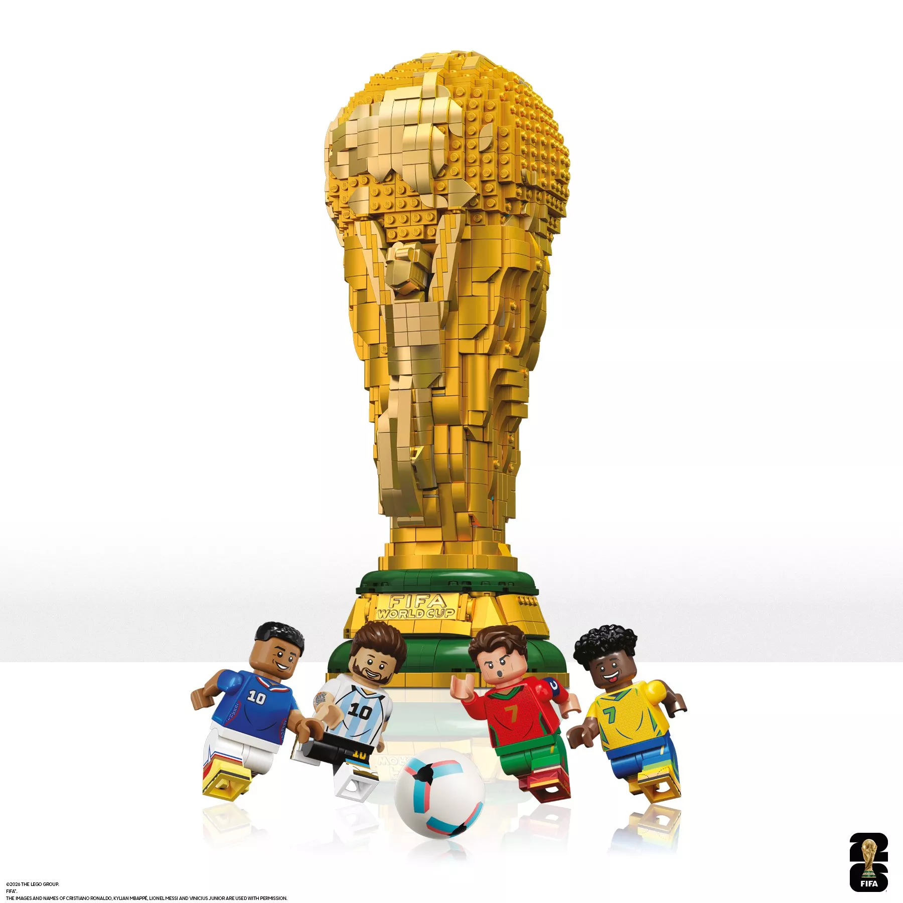 Teen holding LEGO FIFA World Cup trophy model indoors, close-up of hands and detailed brick build