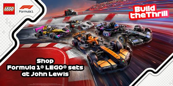LEGO Speed Champions McLaren and Alpine F1 cars racing with safety truck on wet track, stadium backdrop