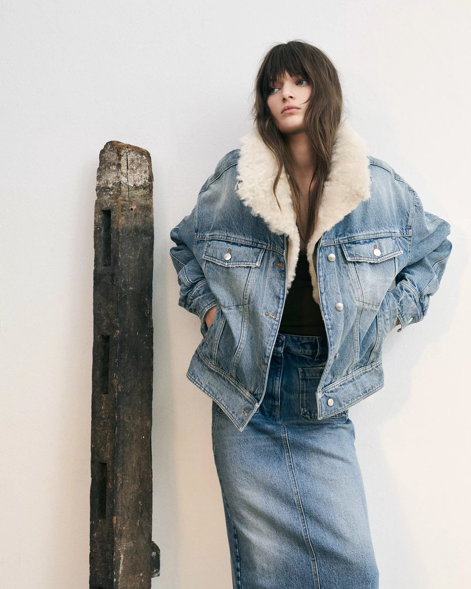 lady in shearling denim jacket and denim skirt
