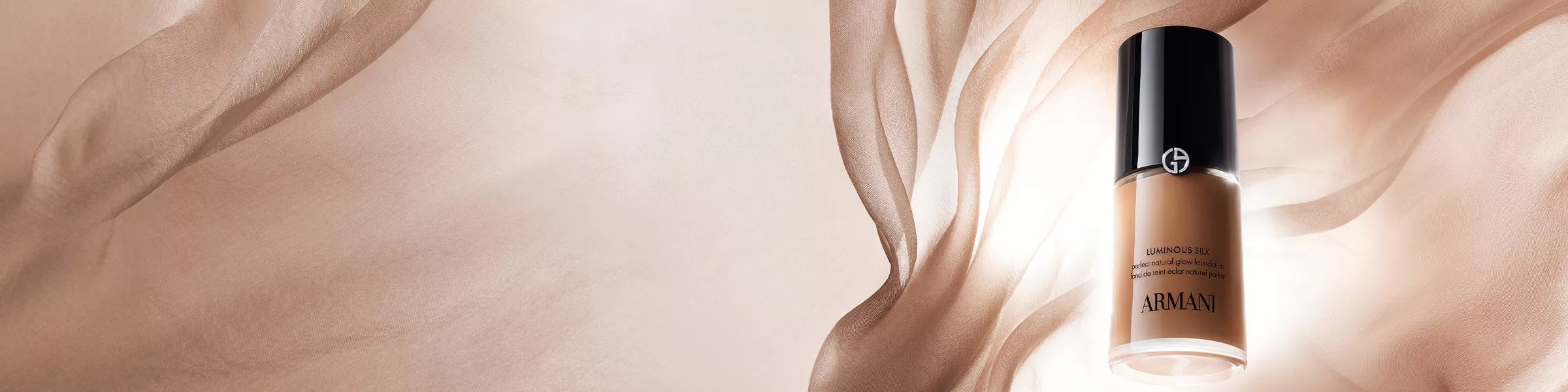 Elegant Armani foundation bottle with silky backdrop, highlighting luxury and beauty. Ideal for radiant skin.