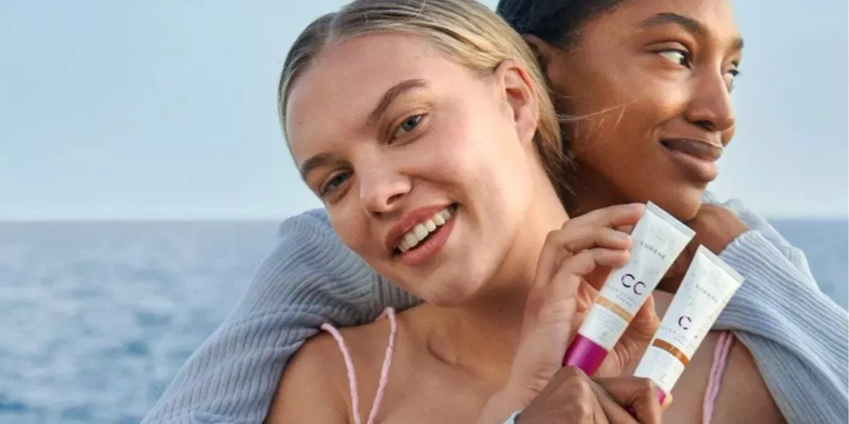 This is brand banner for Lumene with two models holding Lumene products.