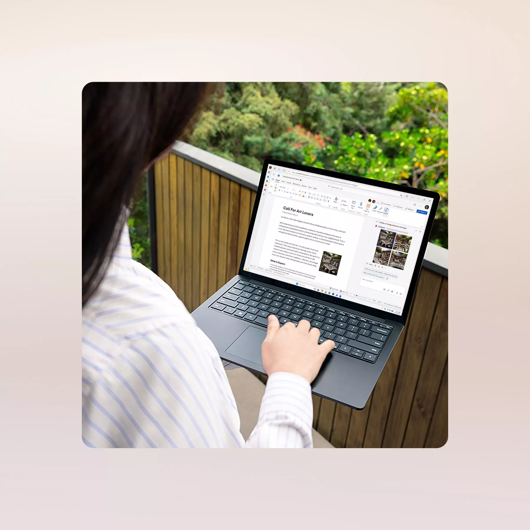 Person using a laptop outdoors, working on a document. Background shows lush greenery and wooden fencing.