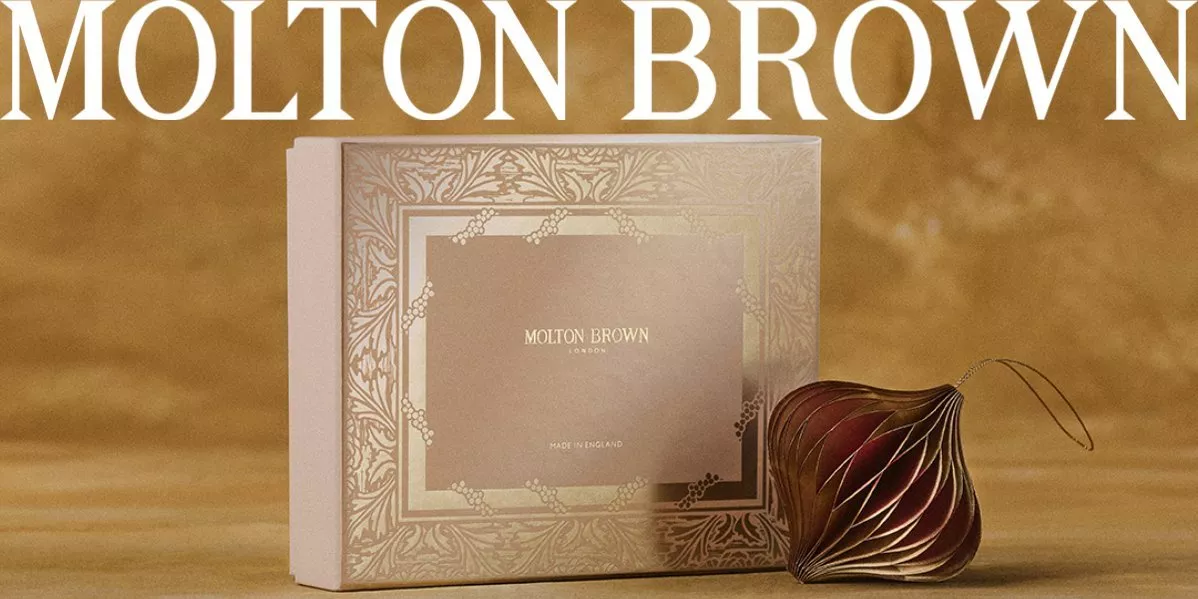 Banner for Molton Brown showing a couple hugging and a Molton Brown gift box.