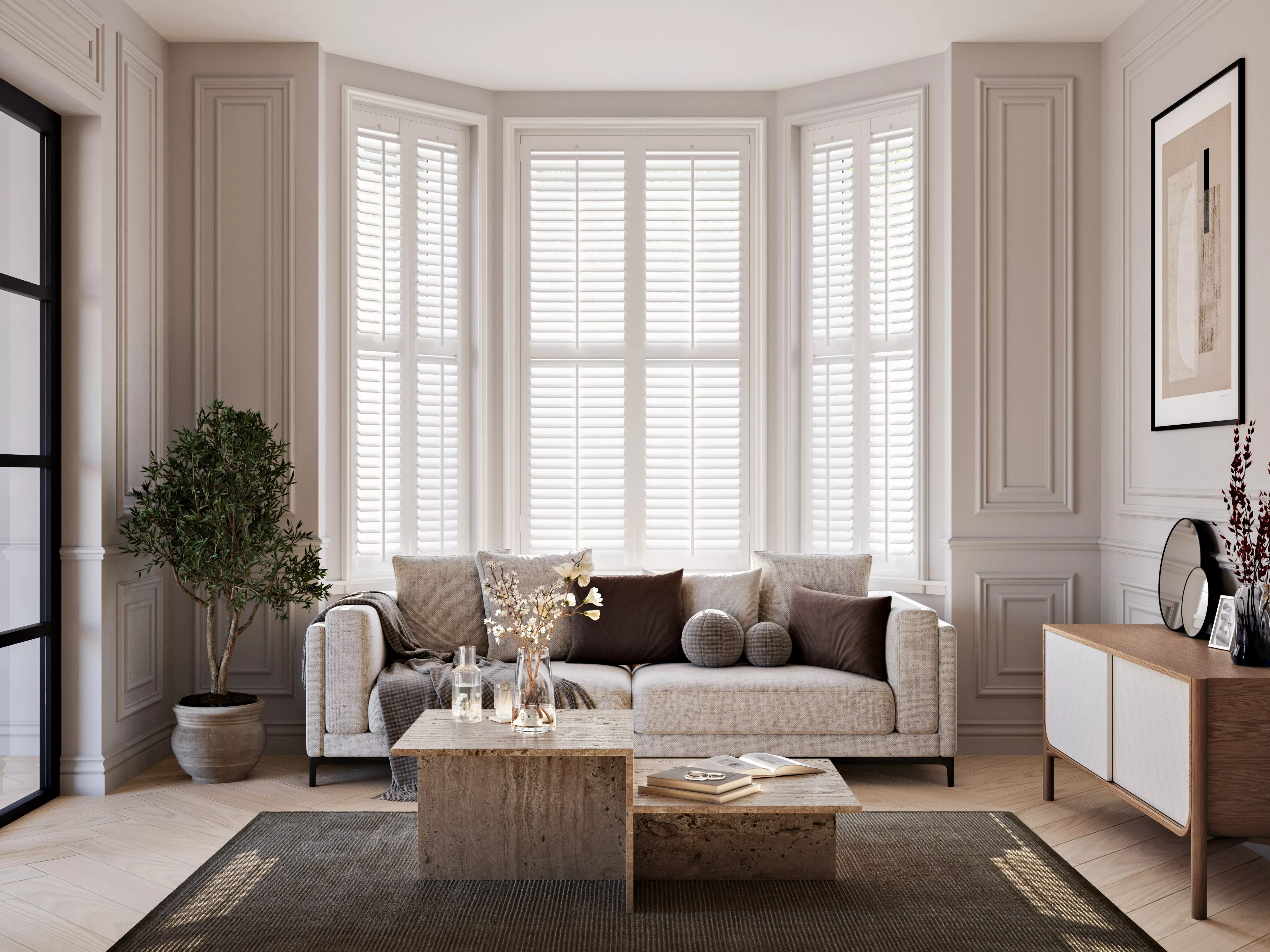 Living room setting with white sofa infront of white floor length shutters