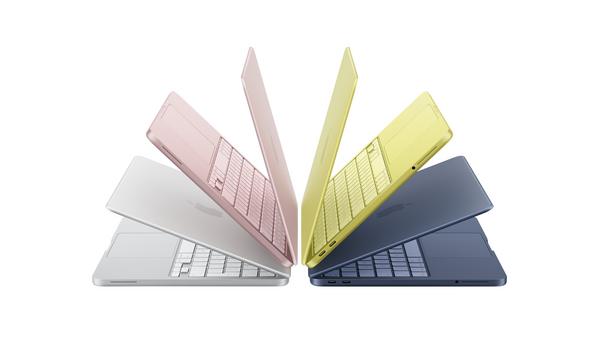 Four laptops, partially open, in pink, yellow, blue, and silver, arranged in a semi-circle on a white background.