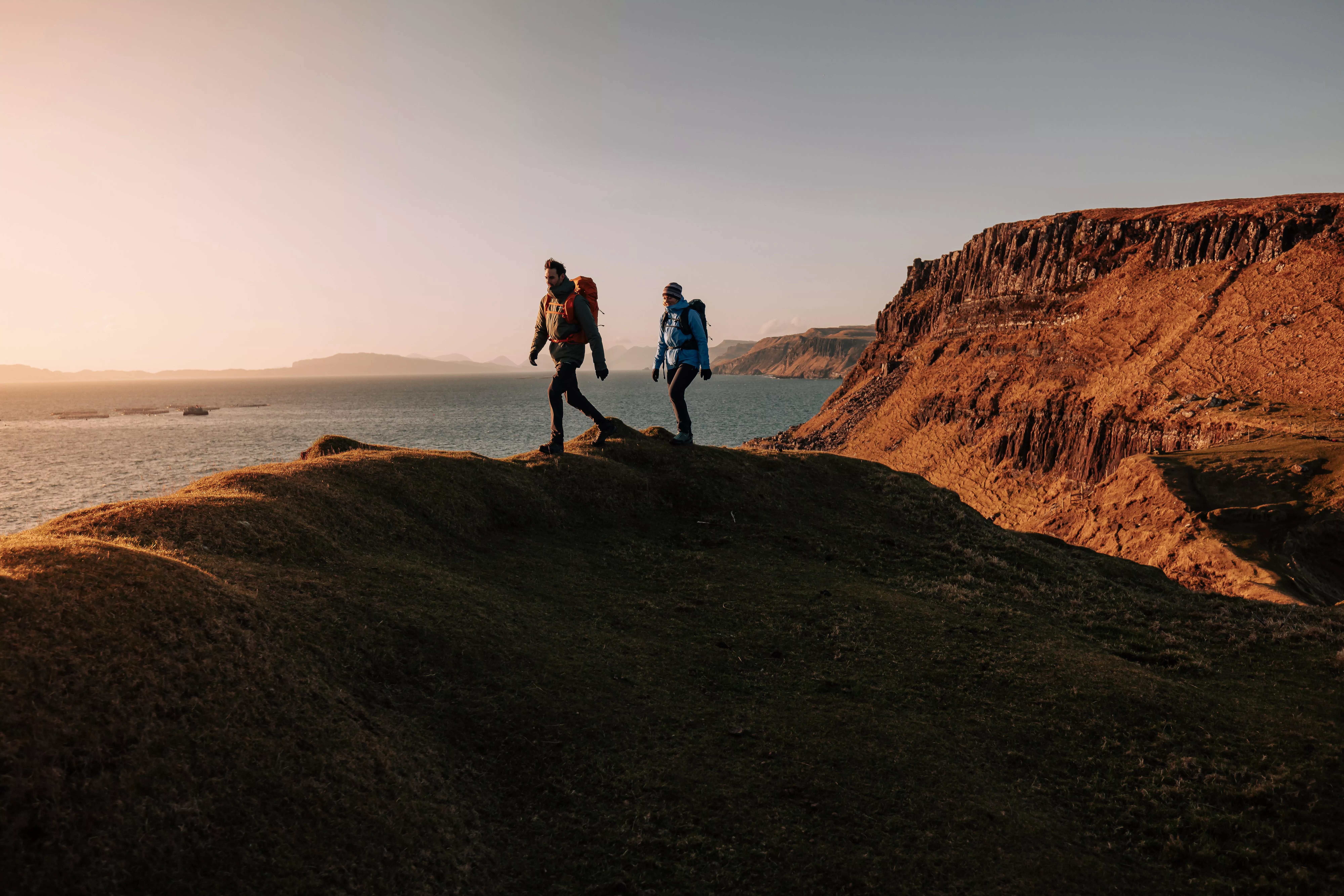 man and woman hiking in a mountainous area 