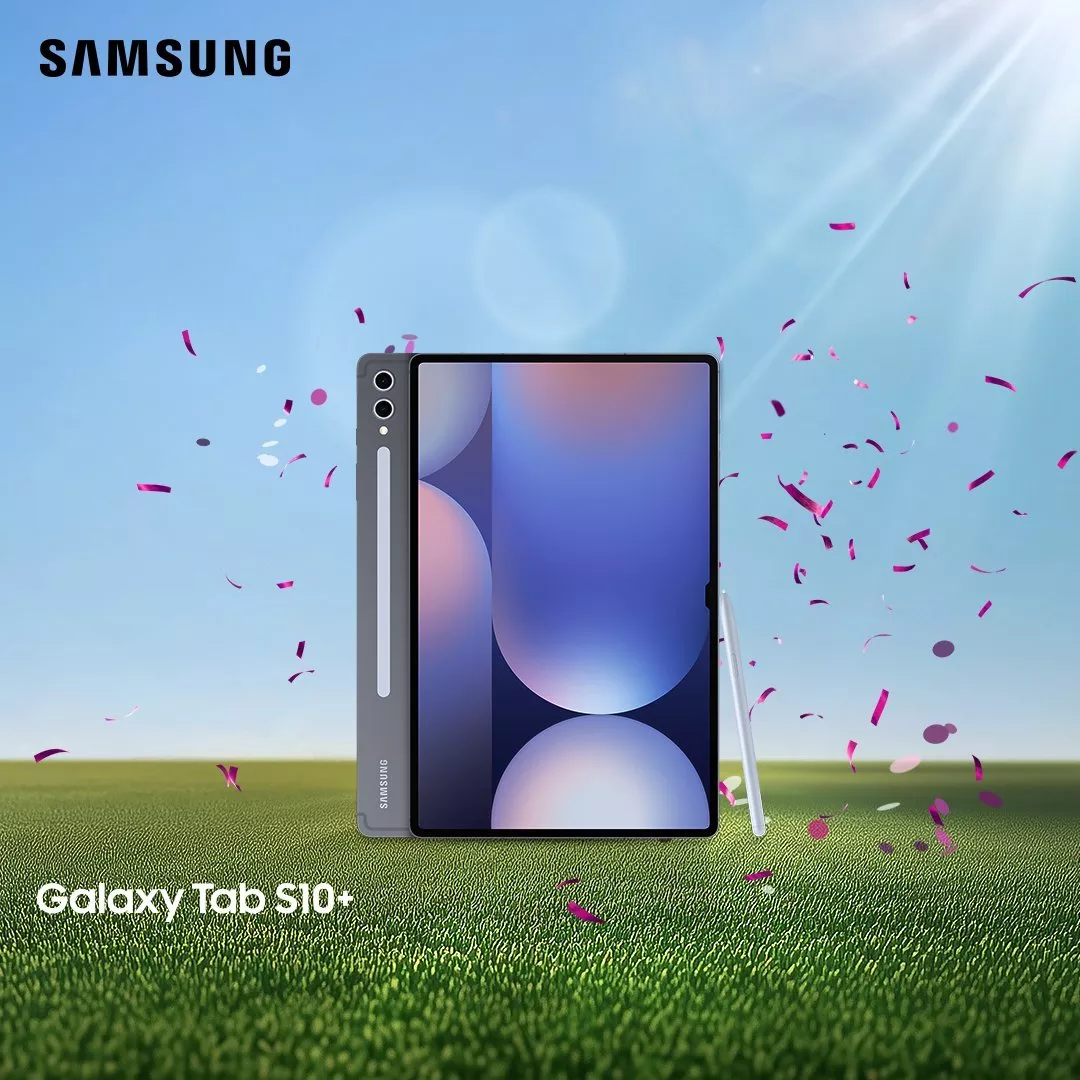 Samsung Galaxy Tab S10 tablet with S Pen on grass under blue sky, confetti falling in sunlight