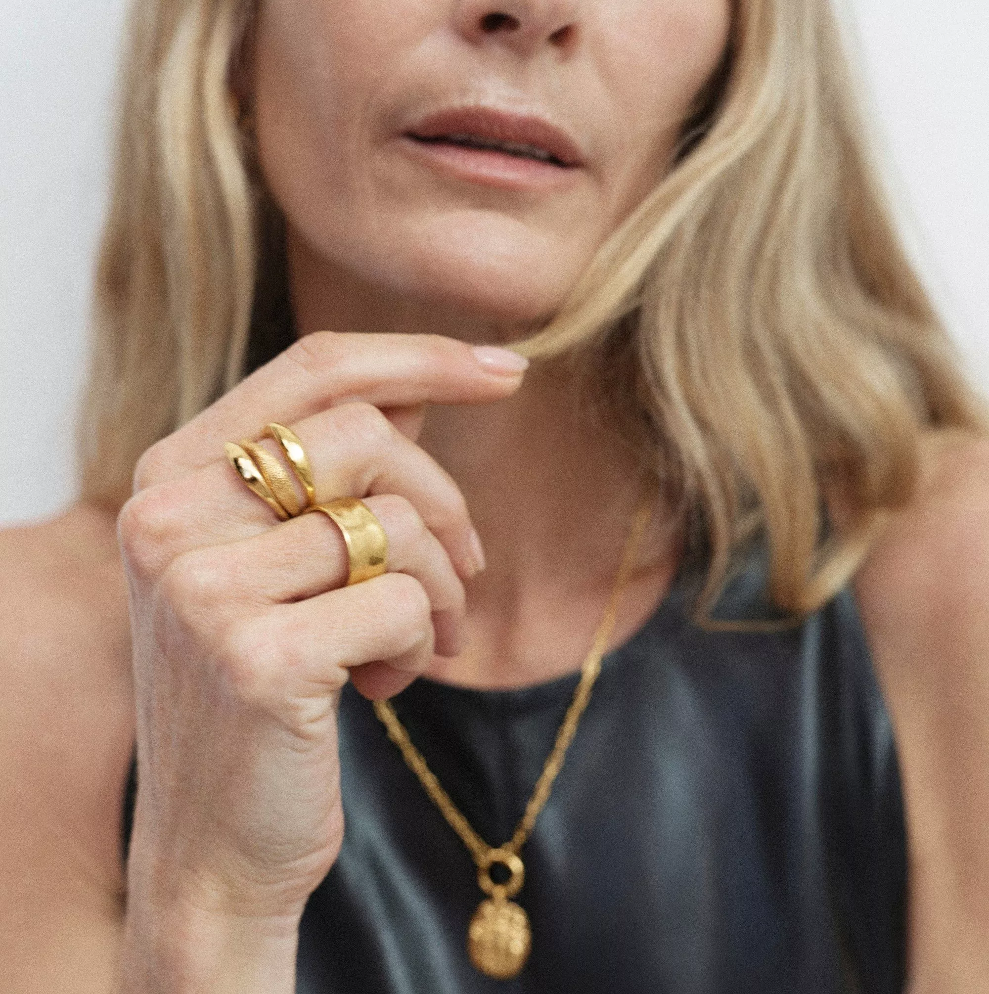 woman wearing monica vinader necklace and rings