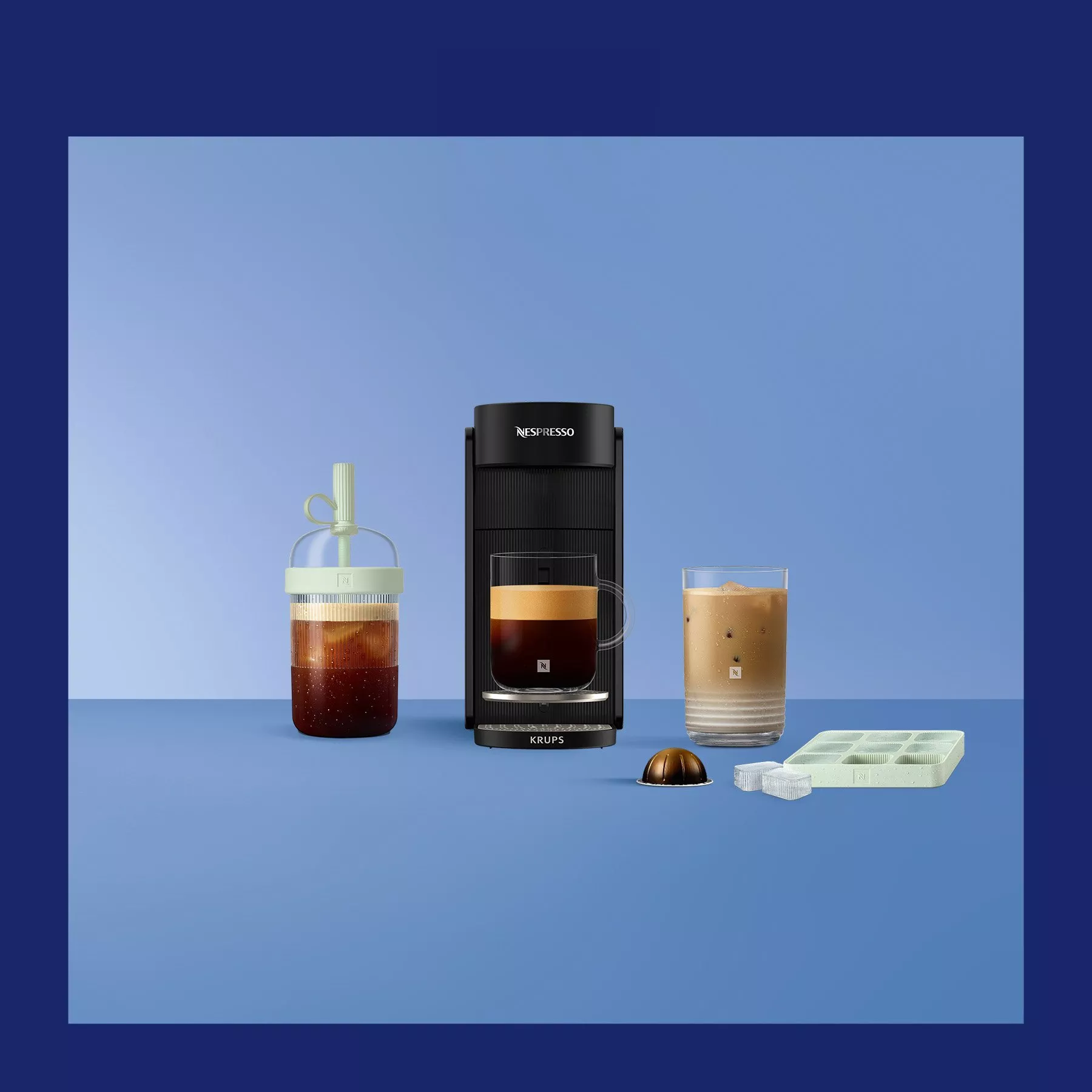 Nespresso Krups coffee machine with iced coffee, capsule pod and ice cube tray on blue background display
