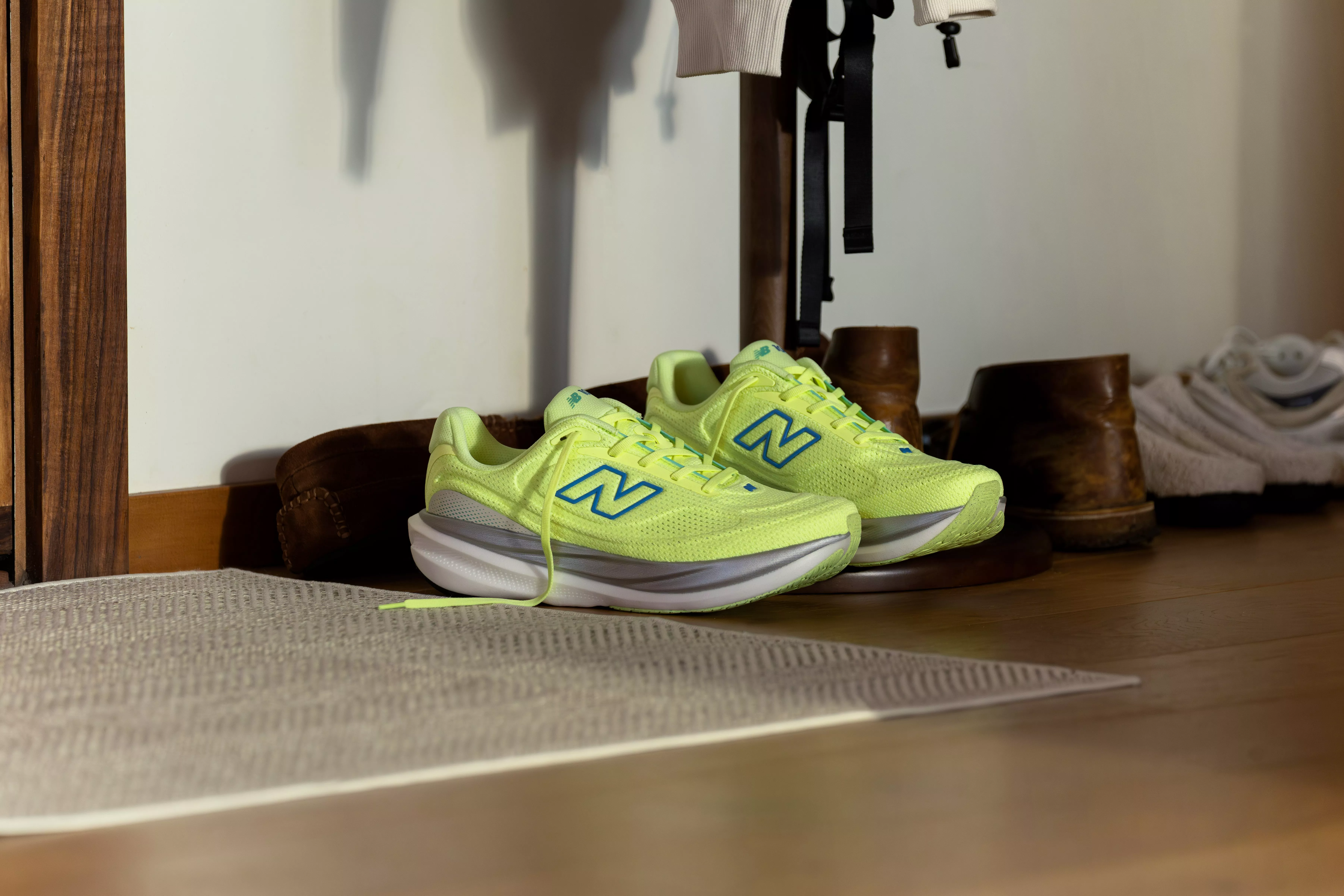 a pair of new balance running shoes in a hallway