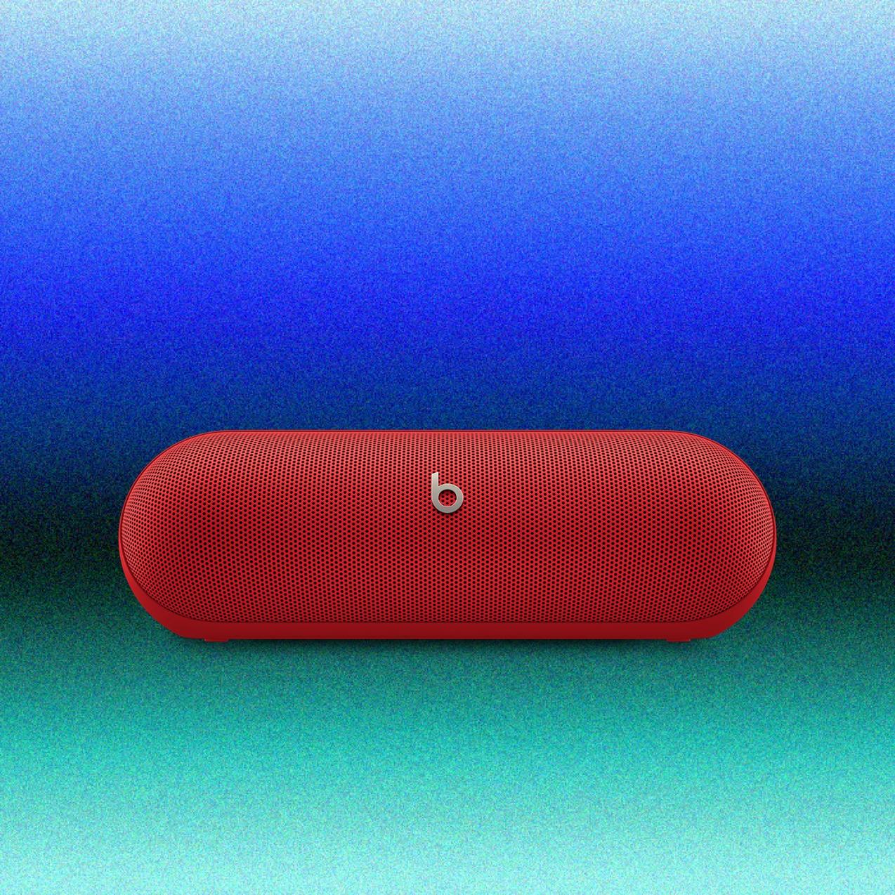 Red Beats Pill portable Bluetooth speaker centered on a blue-to-teal gradient background.