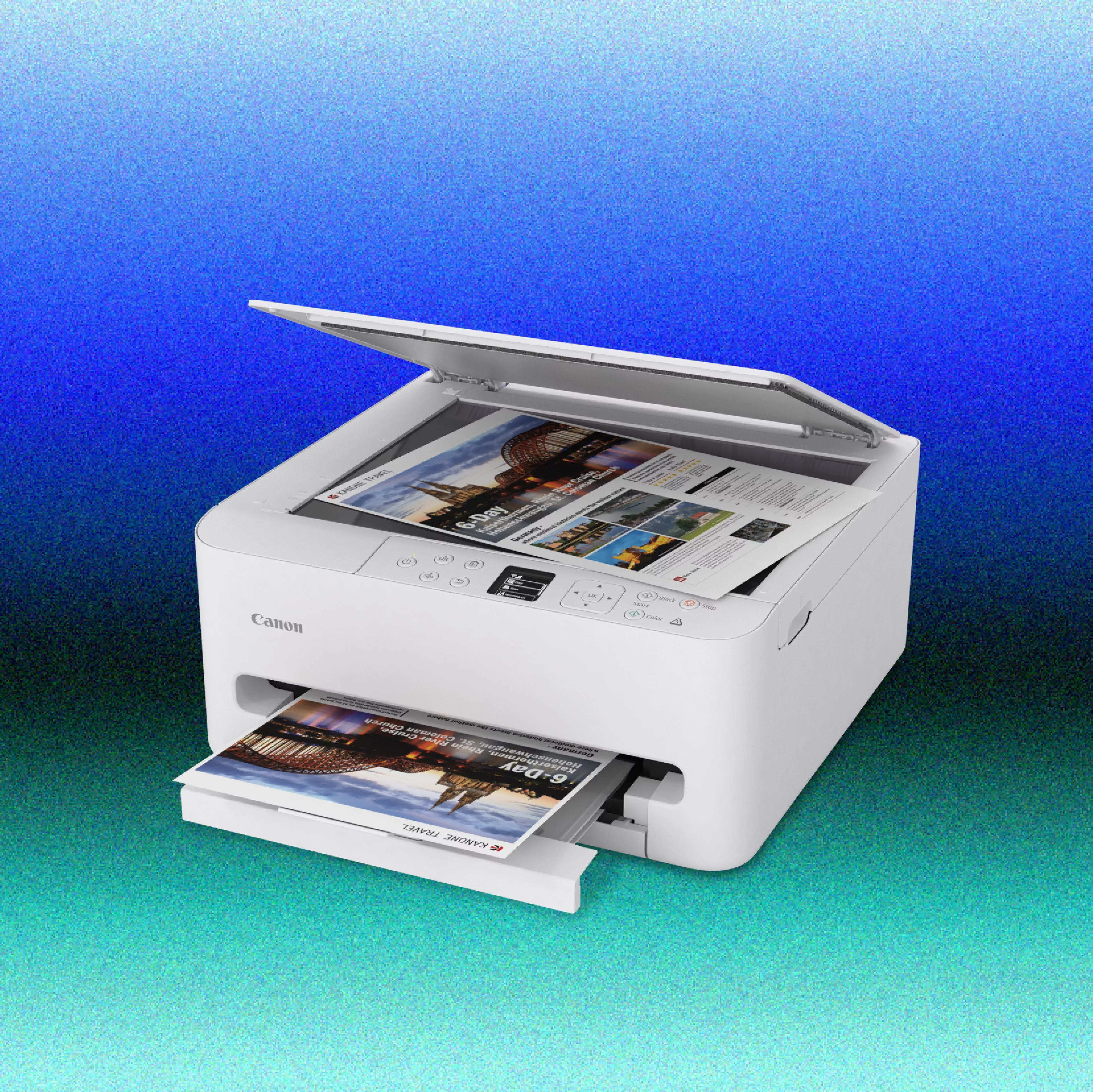 A white Canon all-in-one inkjet printer and scanner on a transparent grid background. The scanner lid is propped open, showing a travel brochure placed on the flatbed glass, whi
