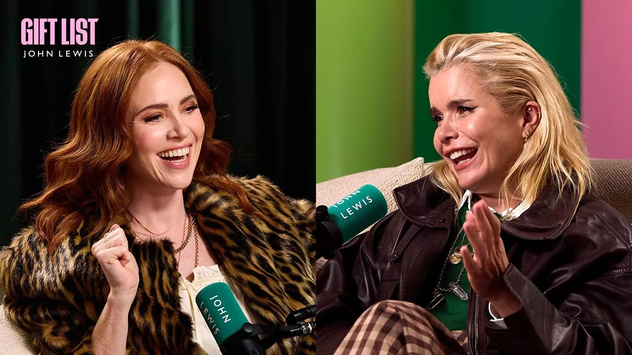Angela Scanlon and Paloma Faith laughing during a John Lewis Gift List interview, with microphones in a colourful studio.