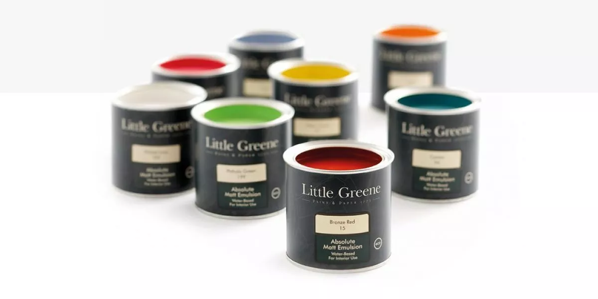 Little Greene paint sample pots in assorted colours on white background, interior wall paint testers for décor choices