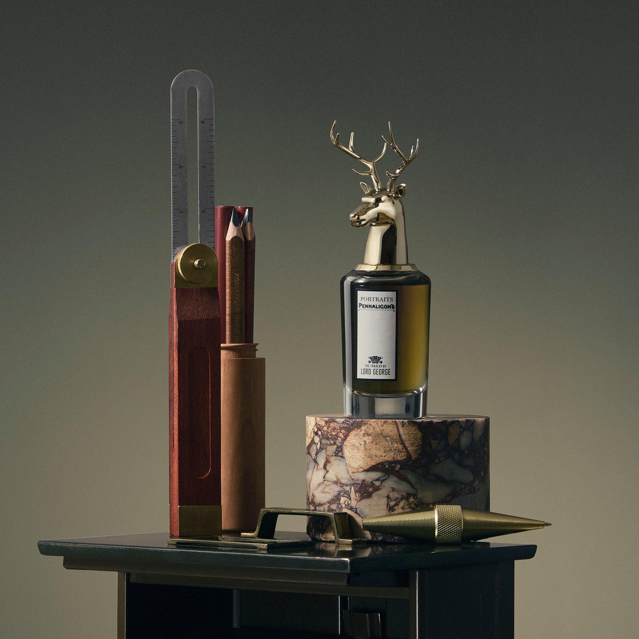 product shot of Penhaligon aftershave on a marble plinth and drawing equipment by the side