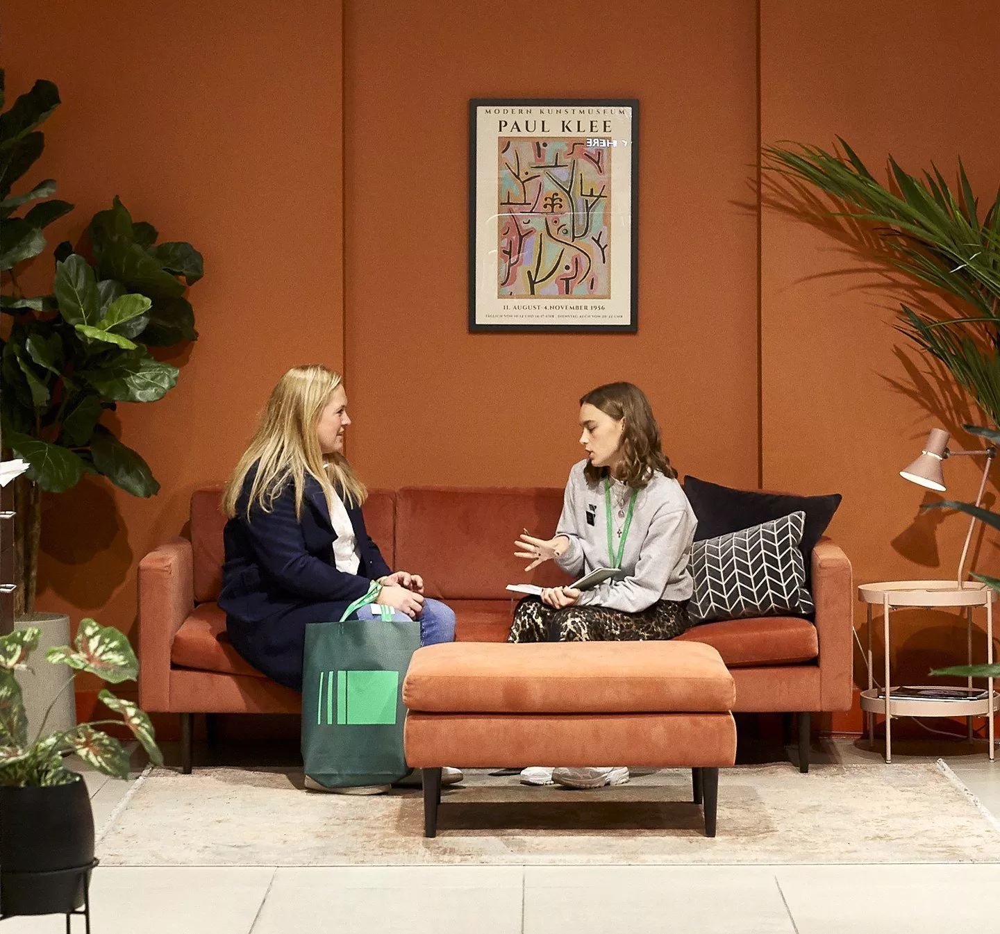 customer and stylist sitting on a sofa talking