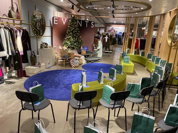image shows a shop floor with chairs and goodie bags laid out; video is a stylist talking about how to book an in-store event