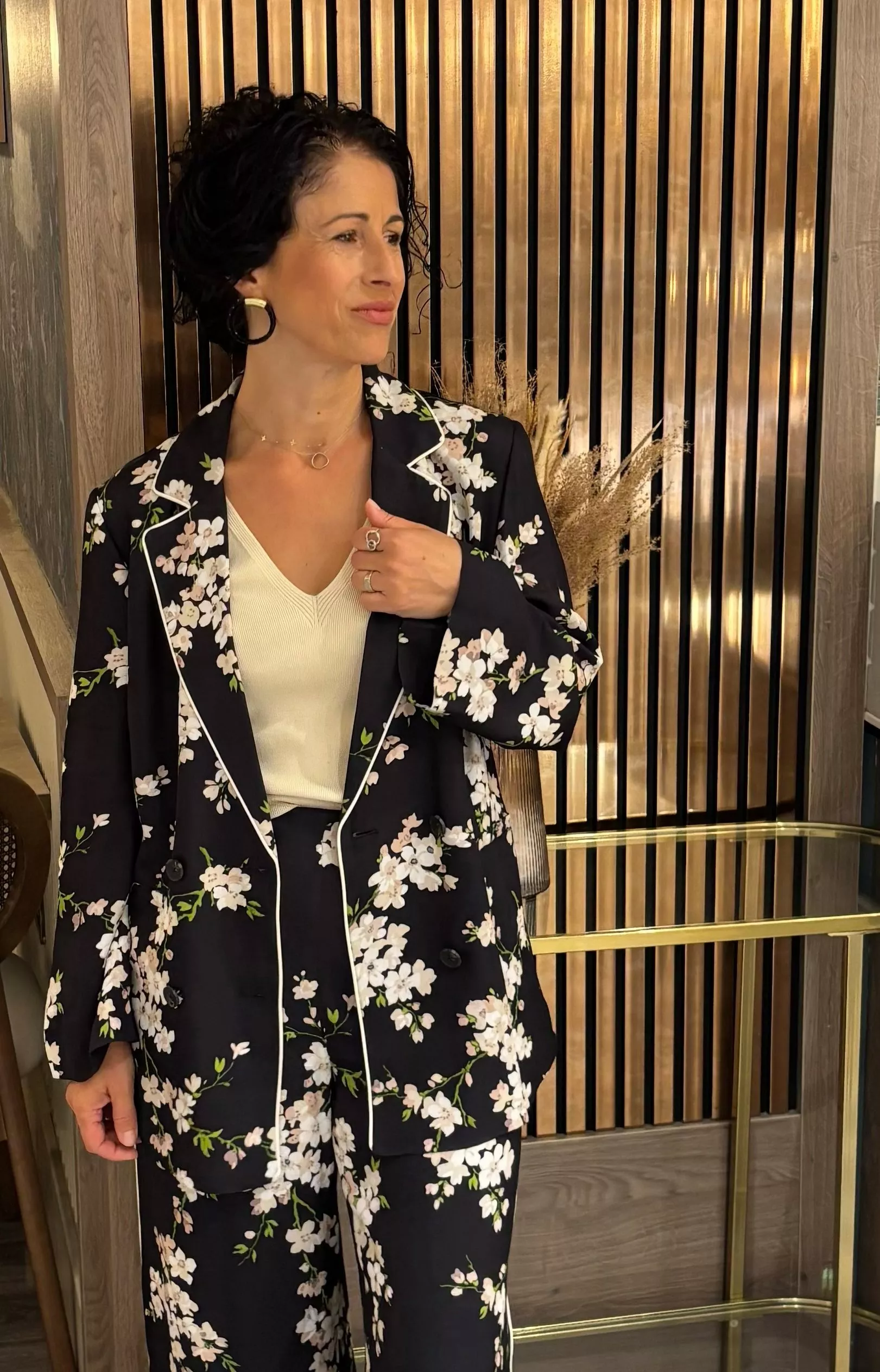 Stylist wearing a black floral matching jacket and trouser suit