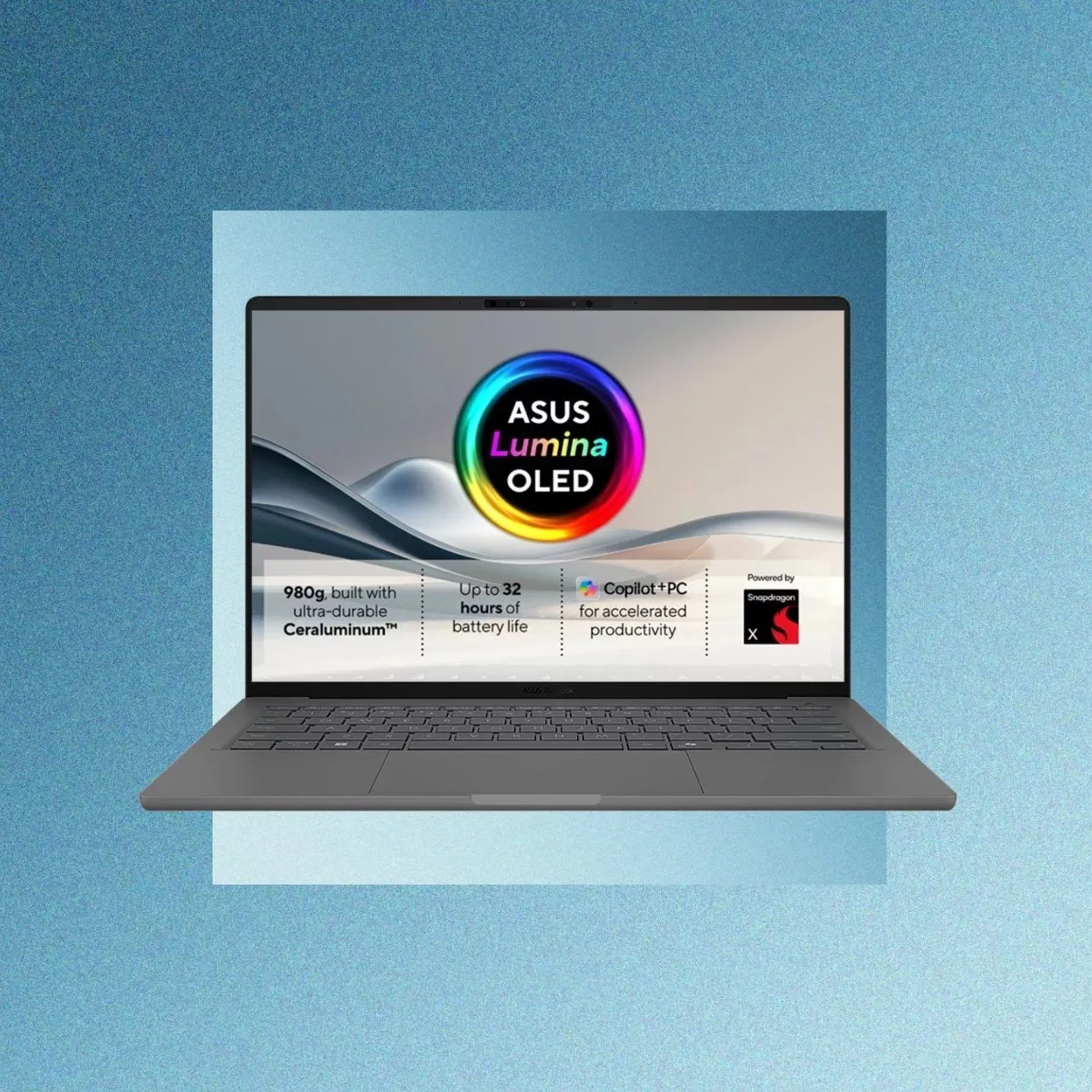 ASUS laptop with Lumina OLED display on blue background, showing 32-hour battery life and Copilot+ PC features
