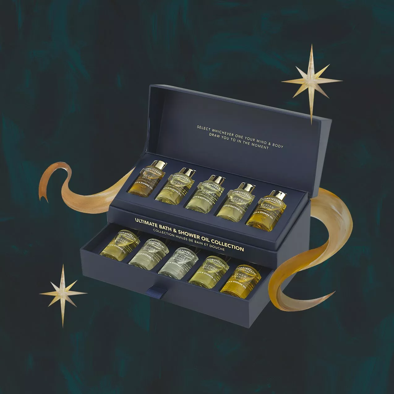 An open navy blue box displaying ten small glass bottles of Aromatherapy Associates bath and shower oils arranged on two tiers.