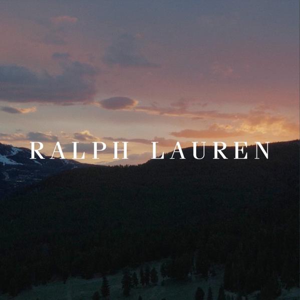 Ralph Lauren logo over a twilight mountain landscape with dark forested hills and a warm sunset sky