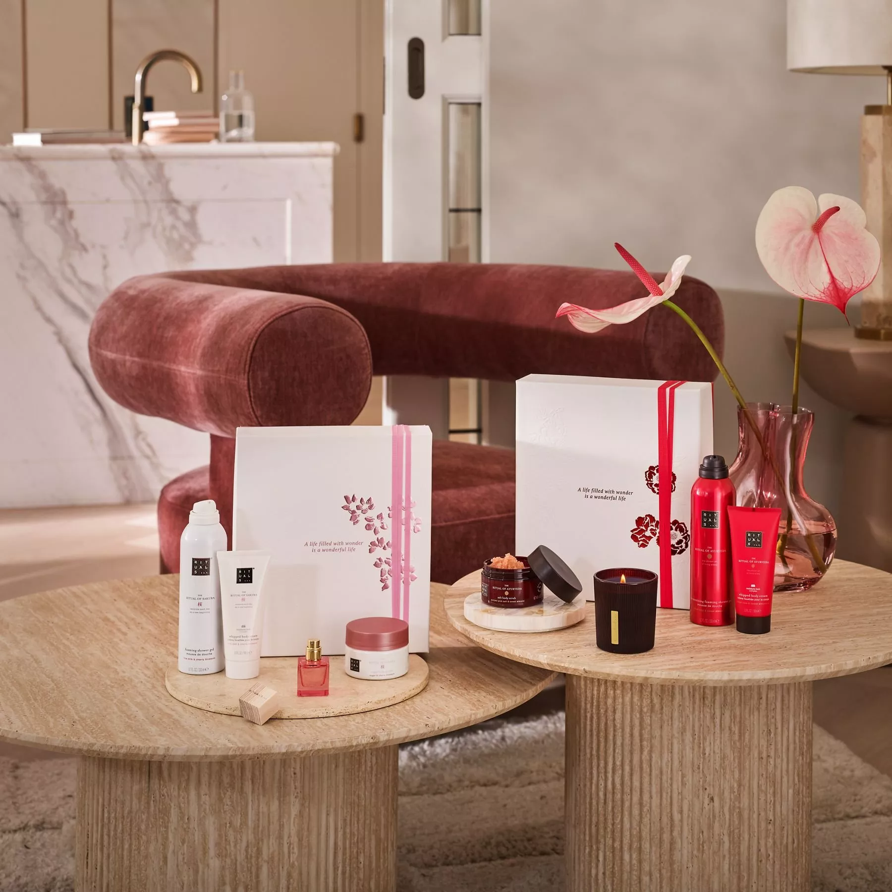 Luxurious skincare products are elegantly displayed on round wooden tables, with a plush red chair and stylish decor.