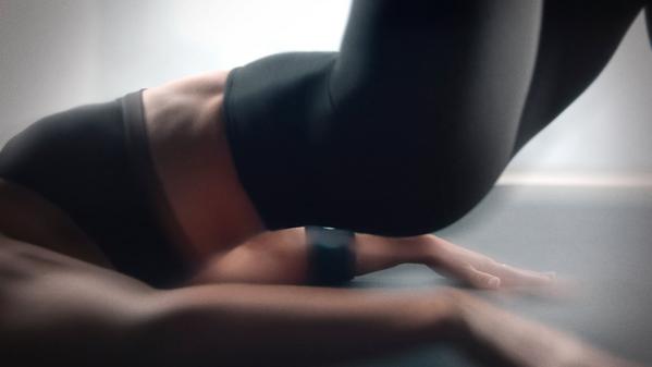 Close-up of woman doing exercising on gym floor, wearing fitness tracker