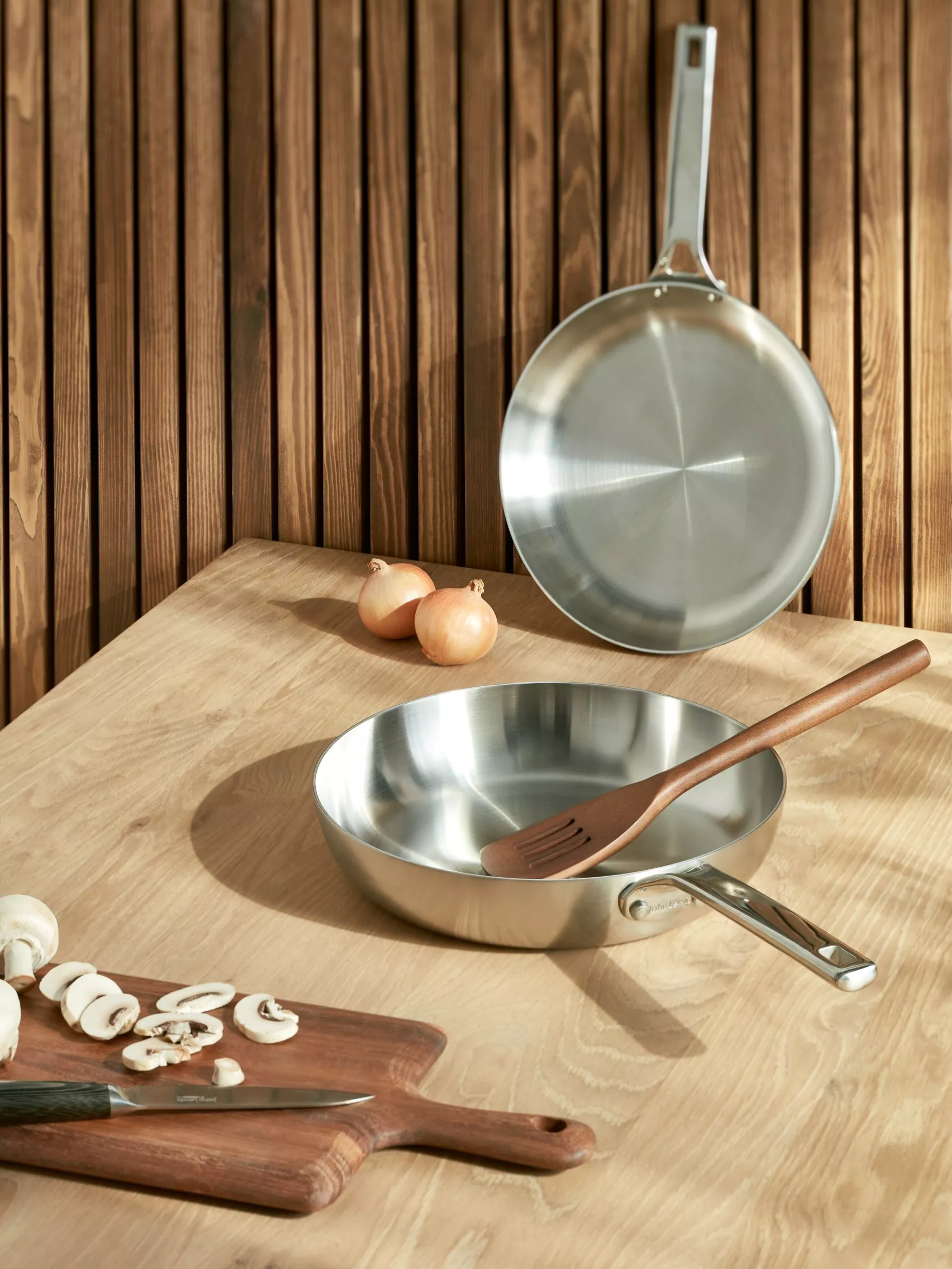 Stainless steel frying pans on a table