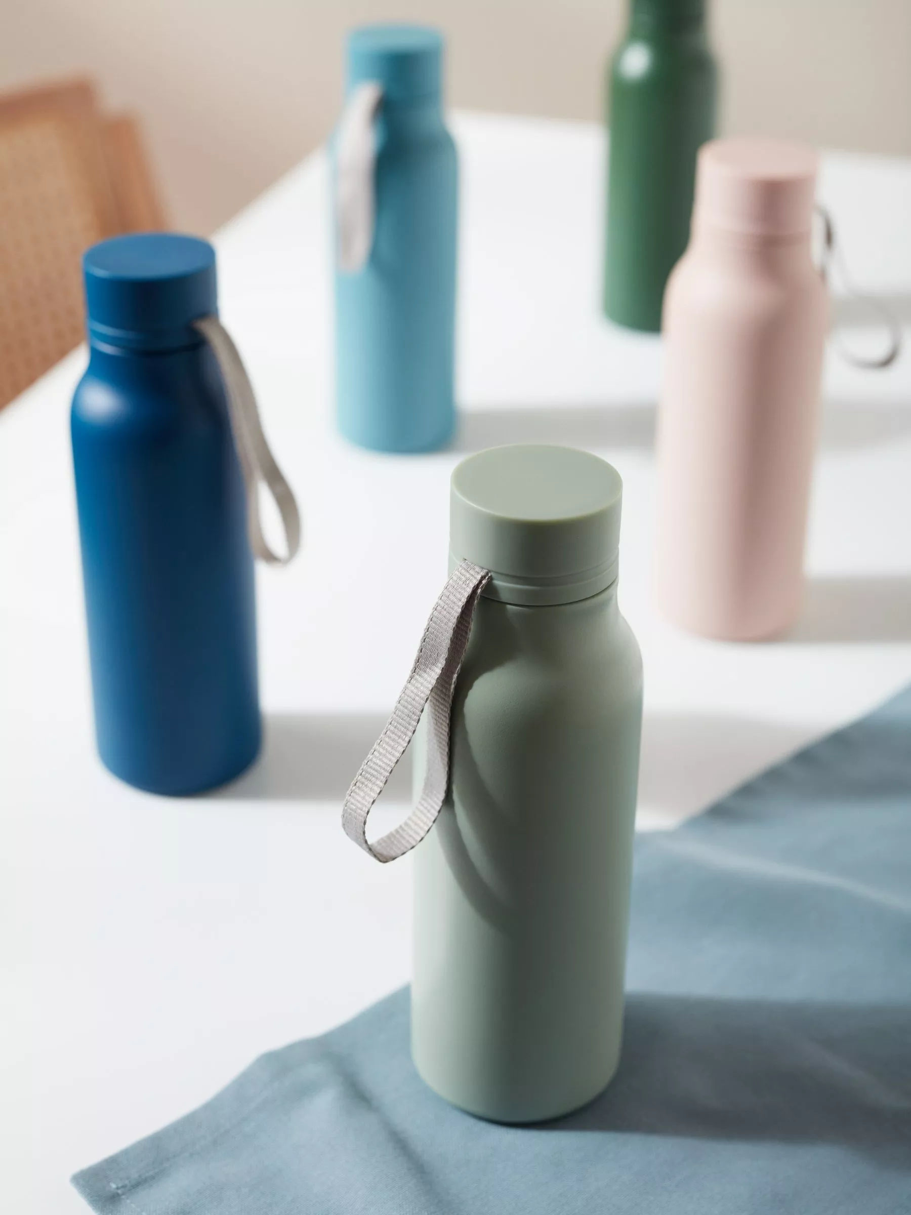 A collection of different coloured water bottles