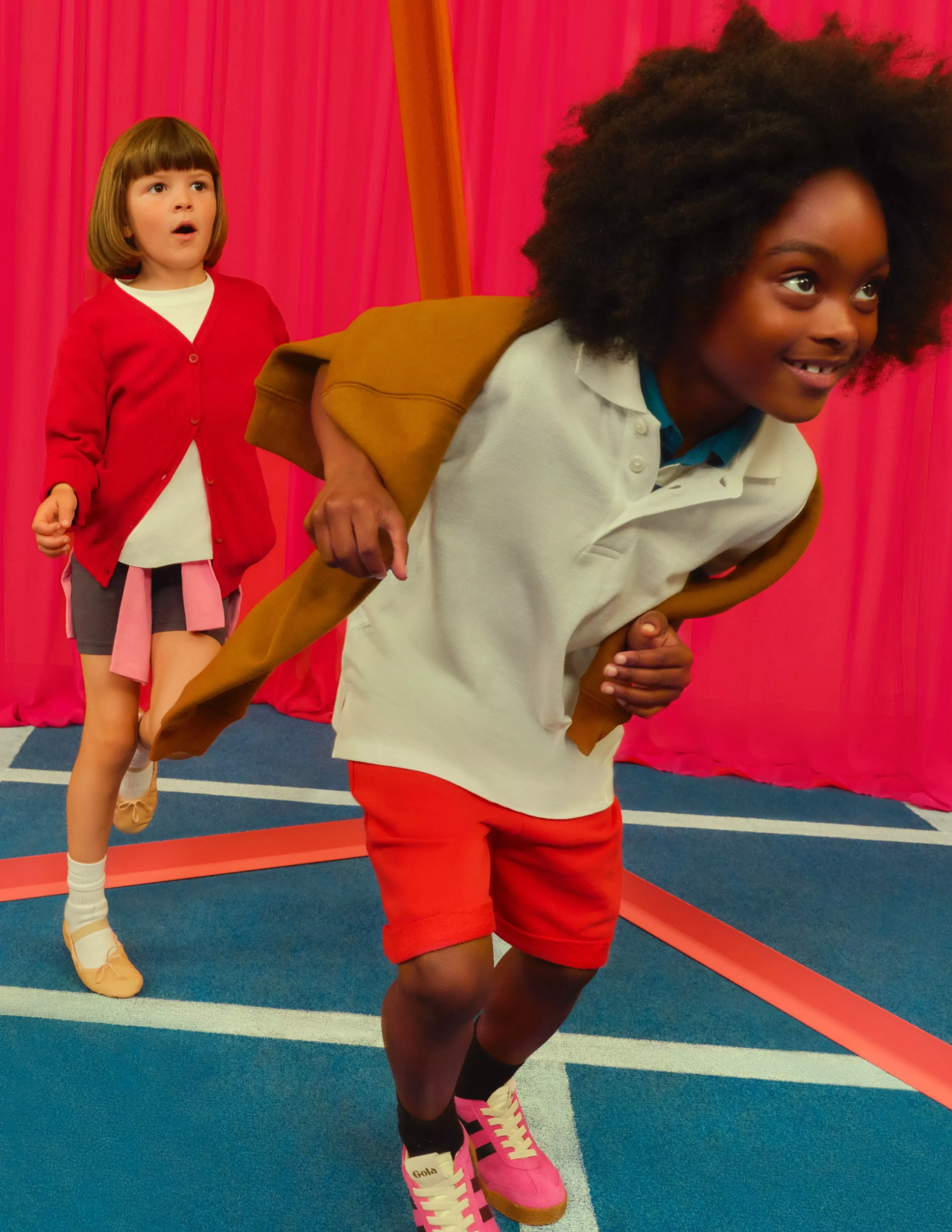 boy running wearing red shorts