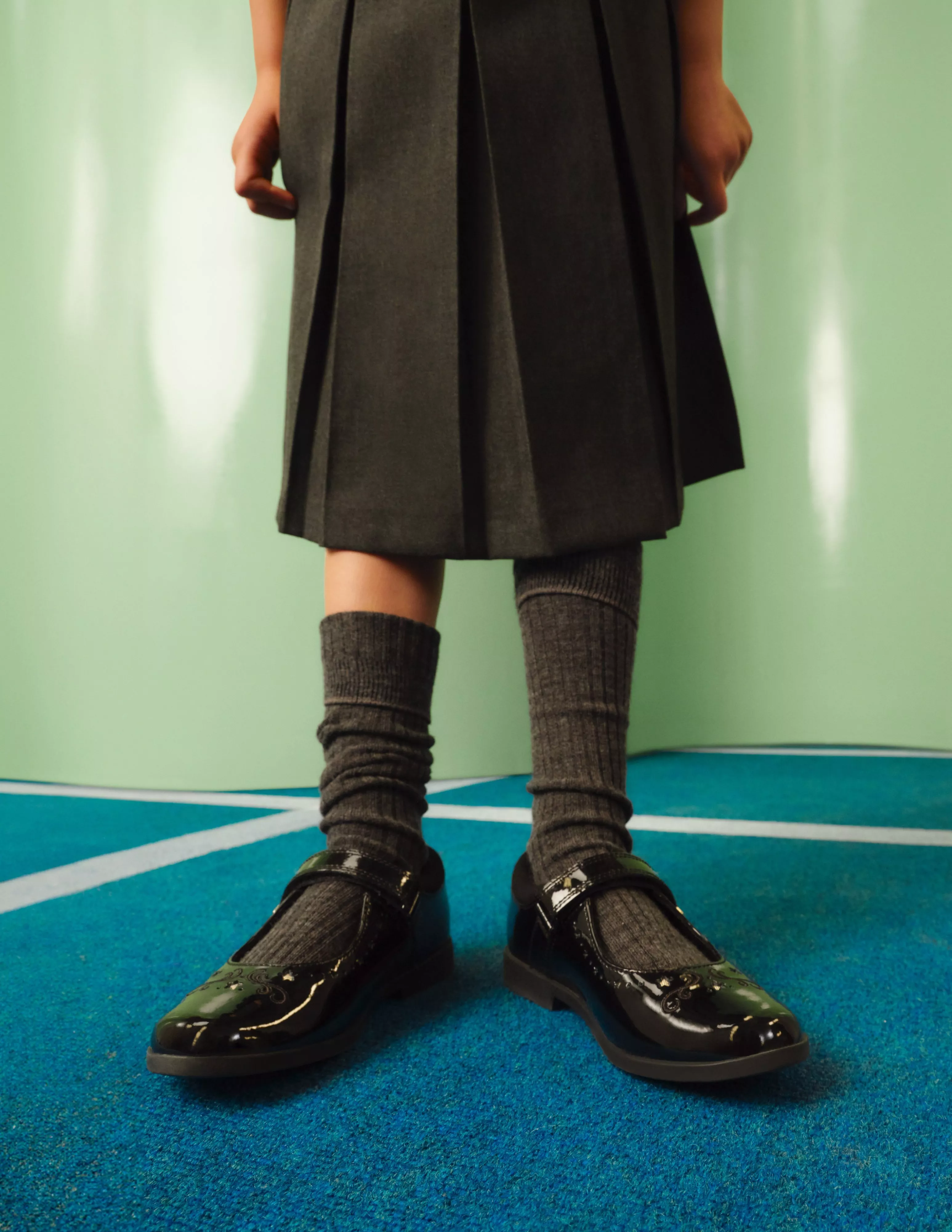 girl wearing shiny buckled black school shoes