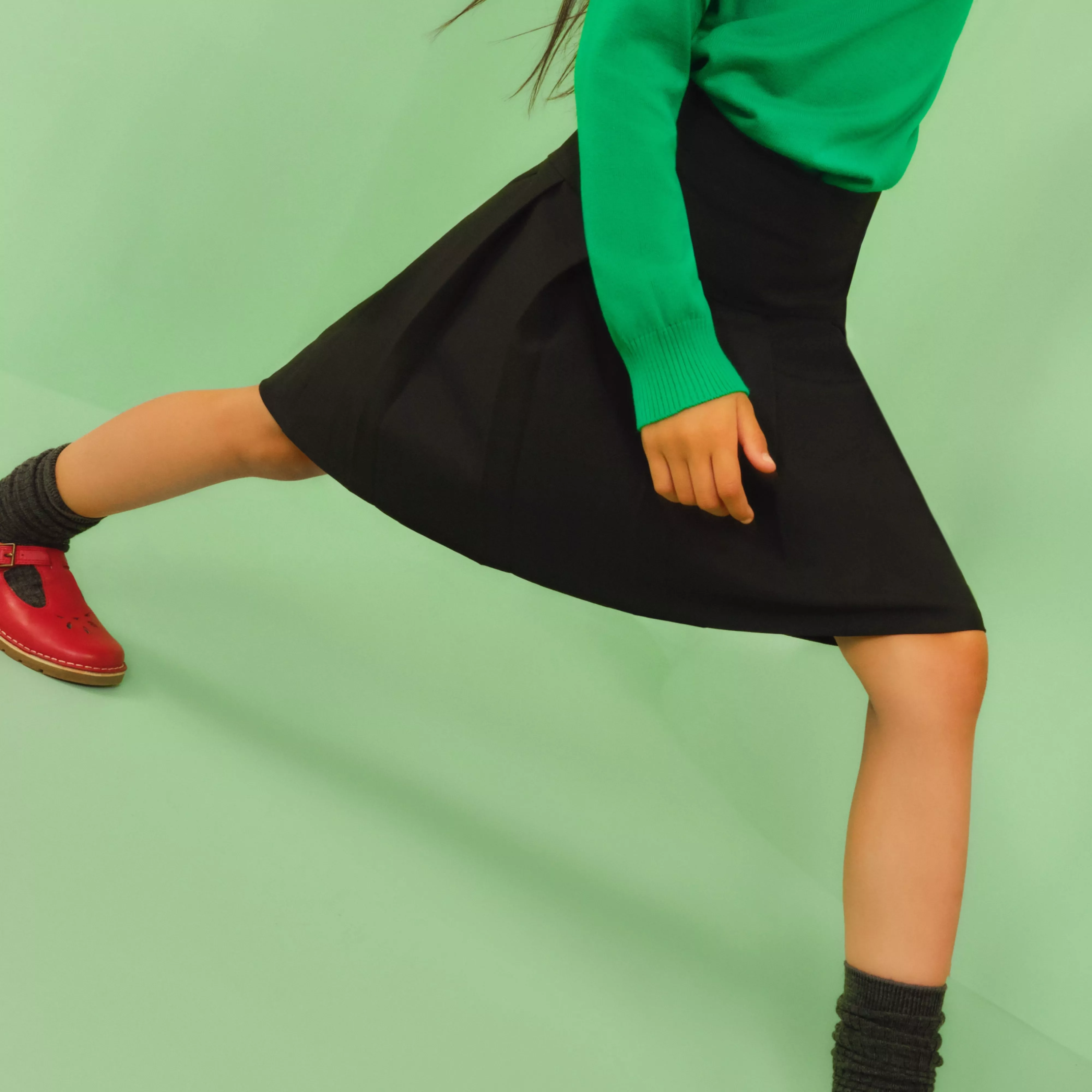 girl wearing a pleated dark grey shirt