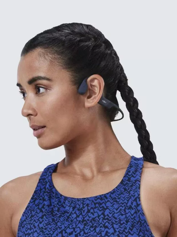 woman wearing wireless open ear headphones