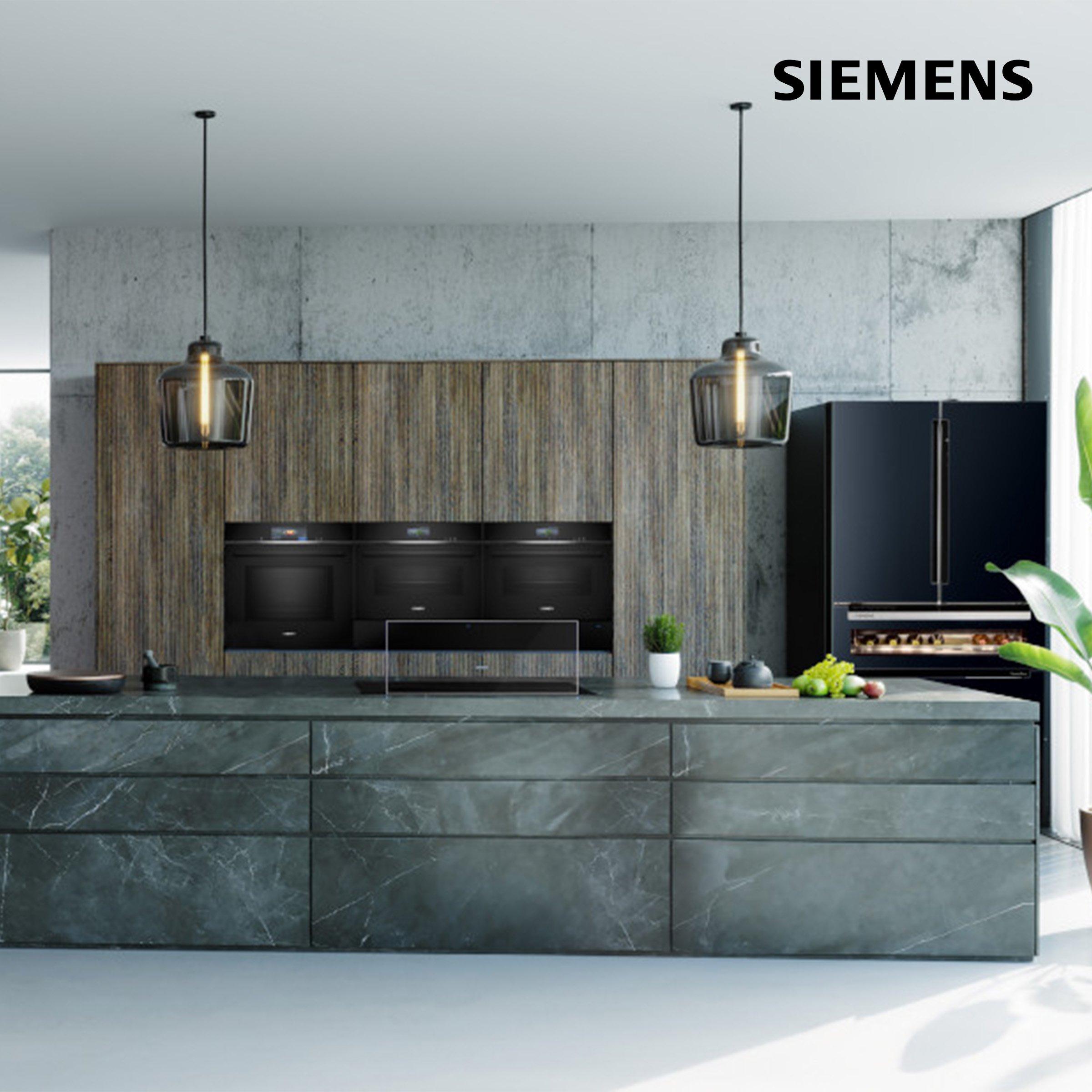 siemen cooking  oven in kitchen area next to big black refrigerator