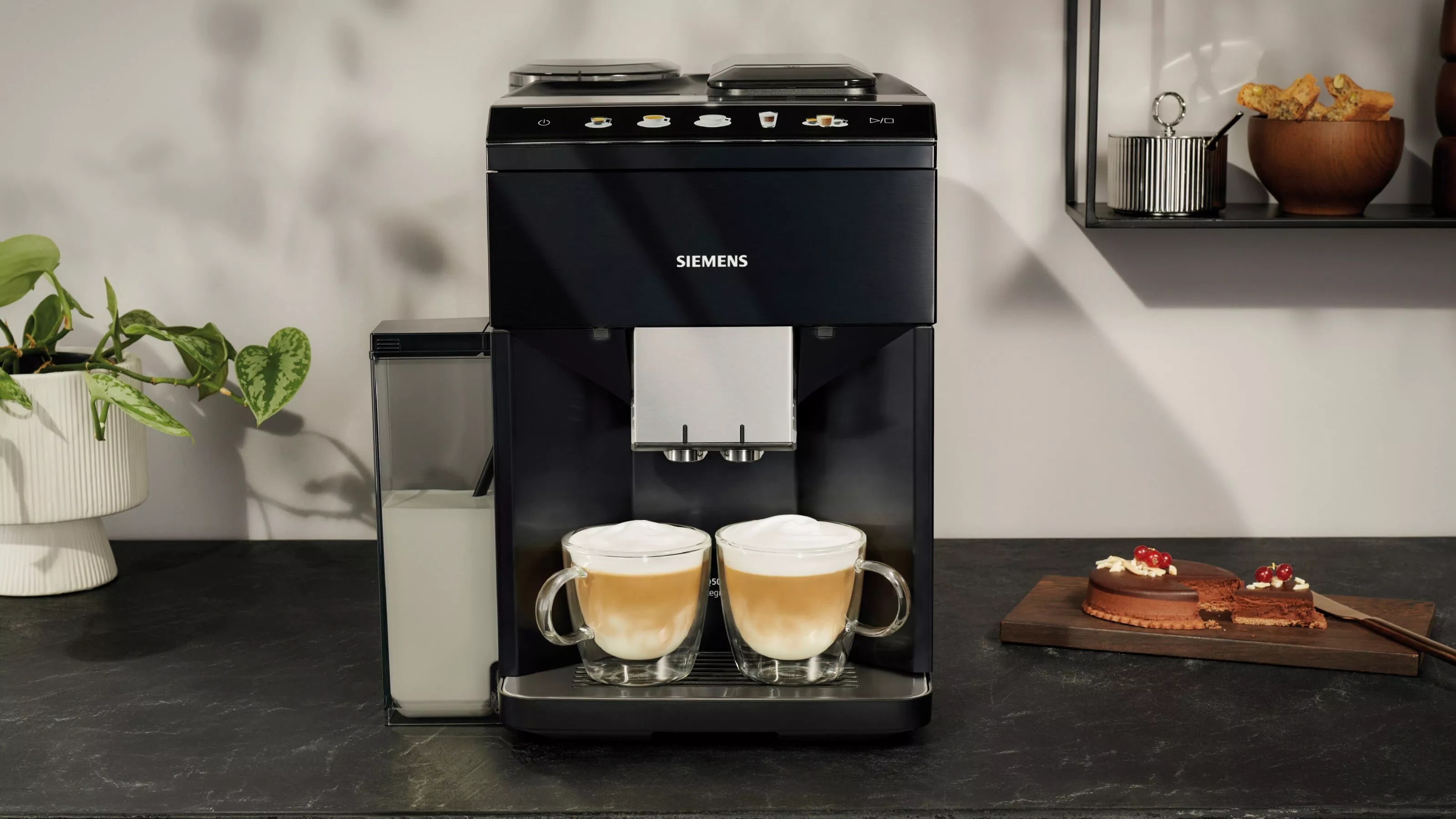 Modern Siemens coffee machine brews espresso macchiato. Background shows iconic global landmarks.
