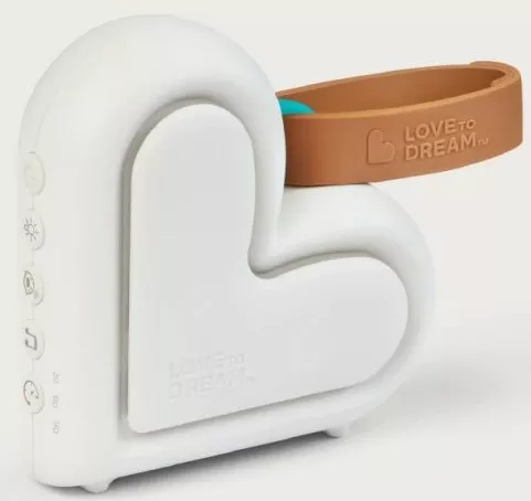 Love To Dream heart-shaped white sleep aid machine with brown strap, soothing sounds and night light for babies