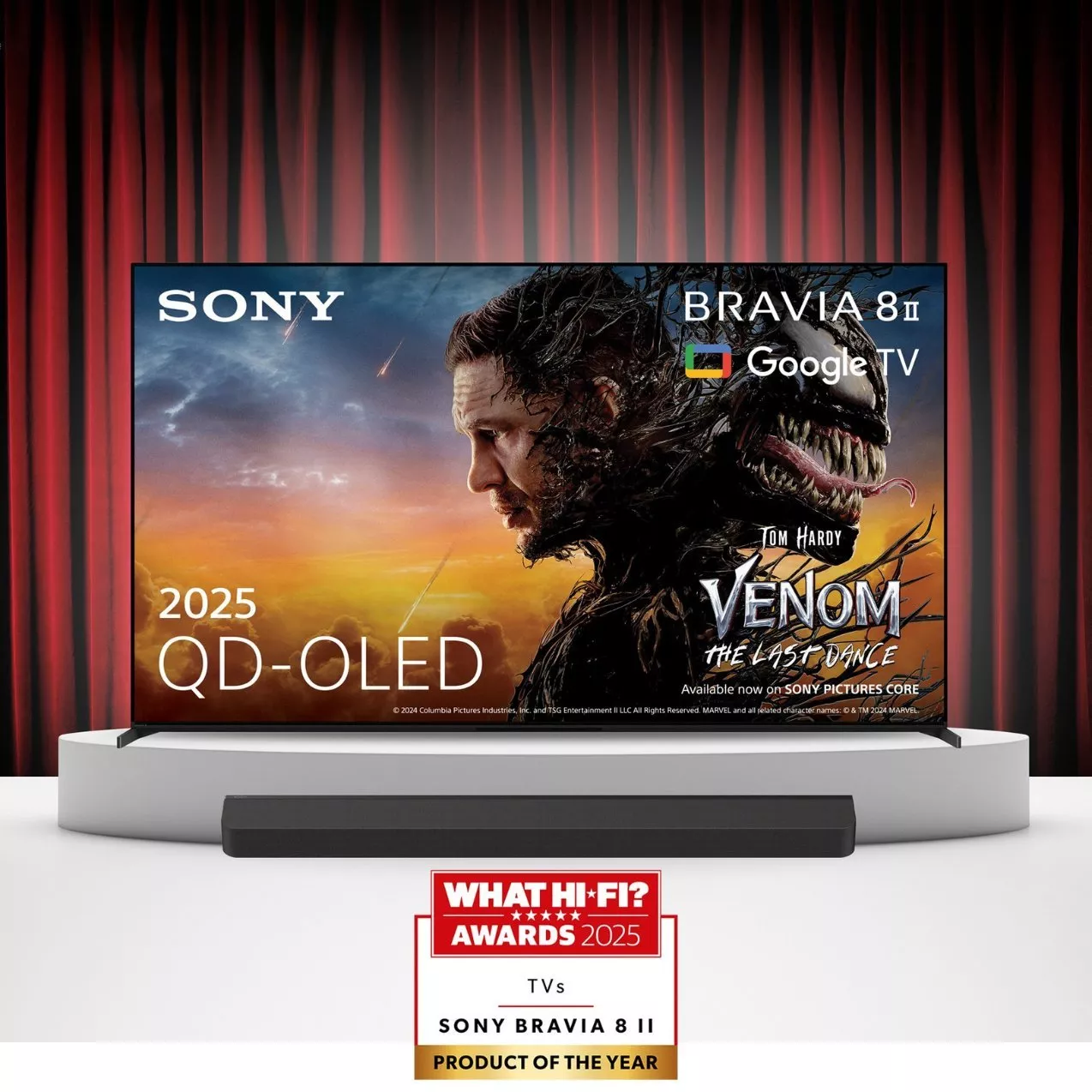 A Sony Bravia 8 II QD-OLED TV displaying a Venom movie poster on a stage with a red curtain backdrop. A soundbar is in front, and a What Hi-Fi? 2025 Award logo is featured at the bottom.