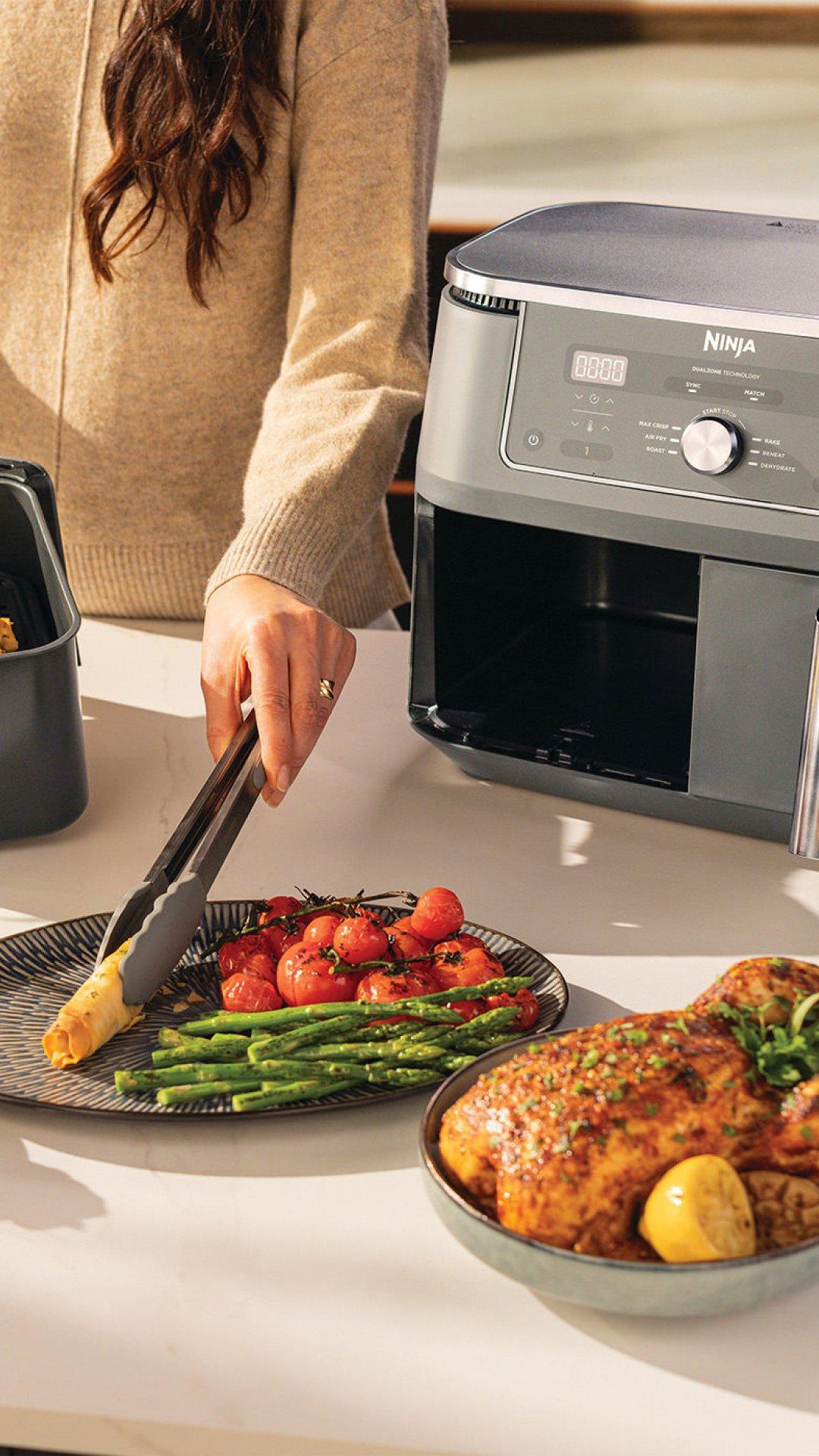 women using a ninja air dryer, dishing out dinner