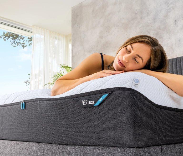 This is banner for Tempur with a person lying on a bed.