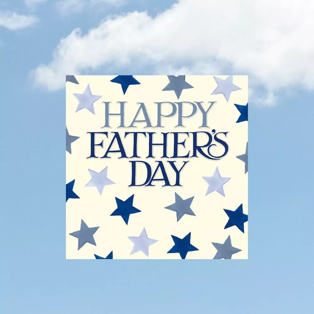 Happy Father’s Day greeting card design with blue star pattern on cream background, set against a sky backdrop