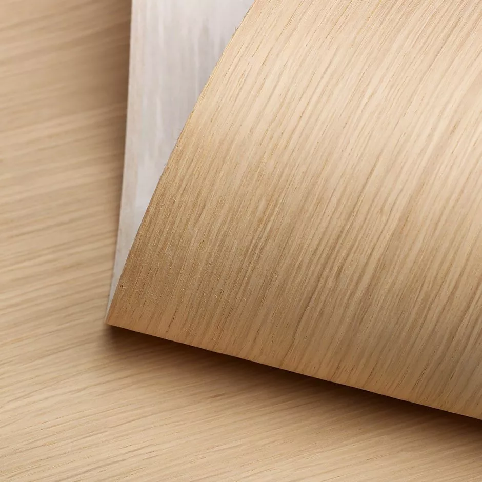 Close-up of light oak wood veneer sheet with natural grain texture, ideal for furniture and interior design finishes